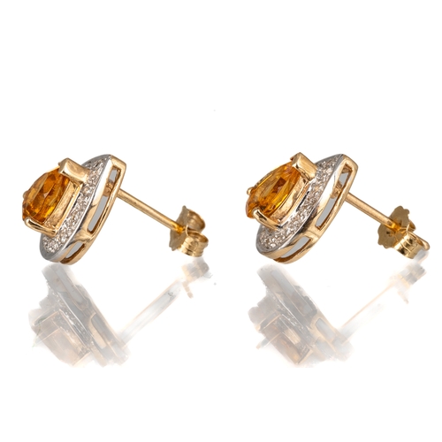 64 - A pair of 14k yellow gold topaz and diamond pear shape stud earrings, the pear-cut topaz approx 1.19... 