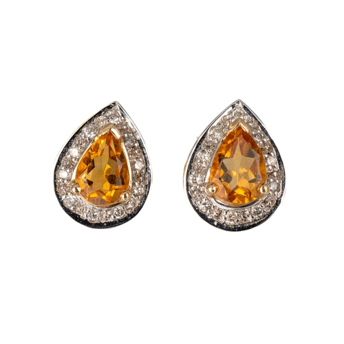 64 - A pair of 14k yellow gold topaz and diamond pear shape stud earrings, the pear-cut topaz approx 1.19... 