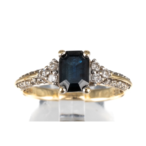 74 - A 10k yellow gold sapphire and diamond ring, set with an emerald-cut sapphire flanked by six diamond... 