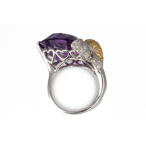 77 - An 18ct white gold diamond and amethyst dress ring, set with a large faceted heart shaped amethyst, ... 