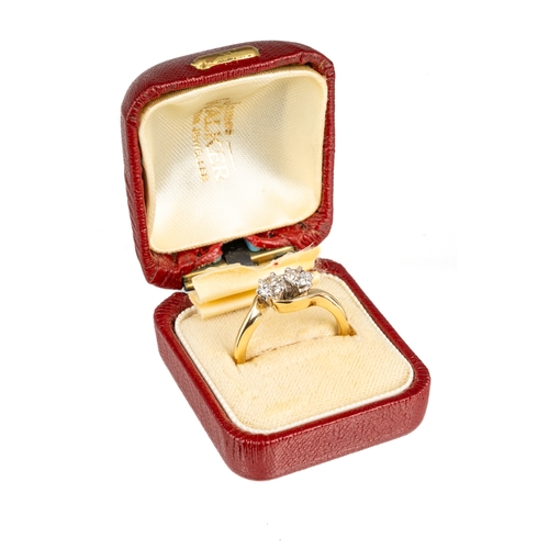 82 - An 18ct yellow gold and diamond two-stone cross-over ring, set with round brilliant-cut diamonds, di... 