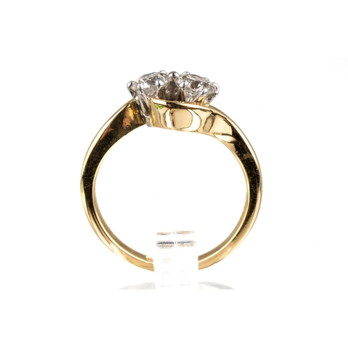 82 - An 18ct yellow gold and diamond two-stone cross-over ring, set with round brilliant-cut diamonds, di... 