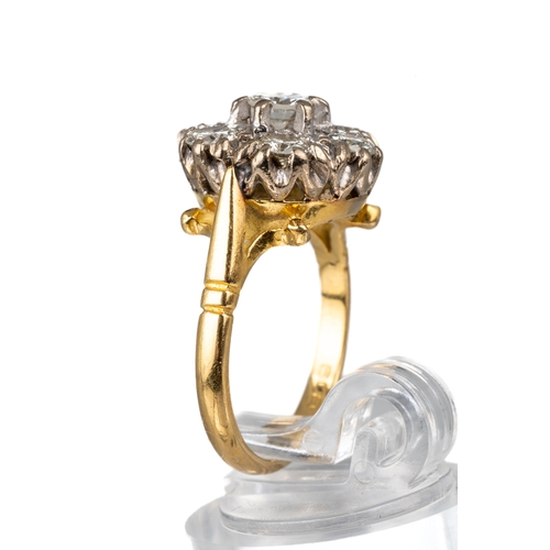 85 - An 18ct yellow gold and diamond seven-stone cluster ring, set with round brilliant-cut diamonds appr... 