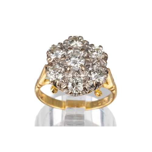 85 - An 18ct yellow gold and diamond seven-stone cluster ring, set with round brilliant-cut diamonds appr... 