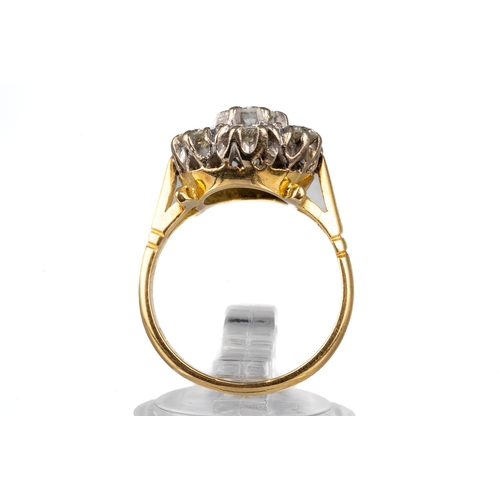 85 - An 18ct yellow gold and diamond seven-stone cluster ring, set with round brilliant-cut diamonds appr... 