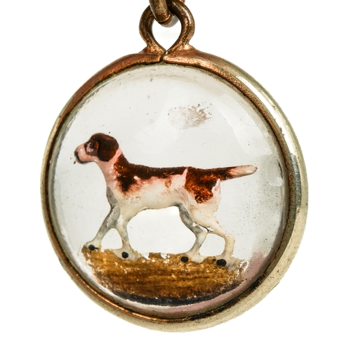 87 - A late 19th/early 20th century reverse painted crystal circular pendant, depicting a hound, approx 1... 