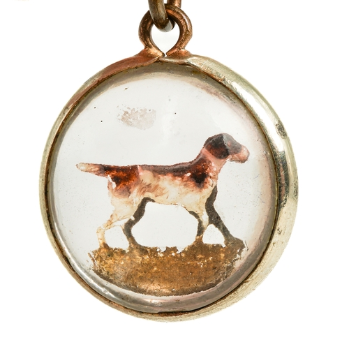 87 - A late 19th/early 20th century reverse painted crystal circular pendant, depicting a hound, approx 1... 