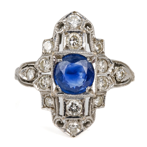 102 - An Art Deco platinum sapphire and diamond dress ring, the central round cut sapphire approx 6.2mm di... 