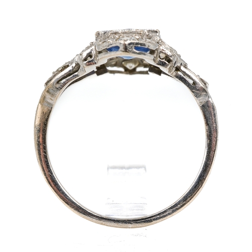 102 - An Art Deco platinum sapphire and diamond dress ring, the central round cut sapphire approx 6.2mm di... 