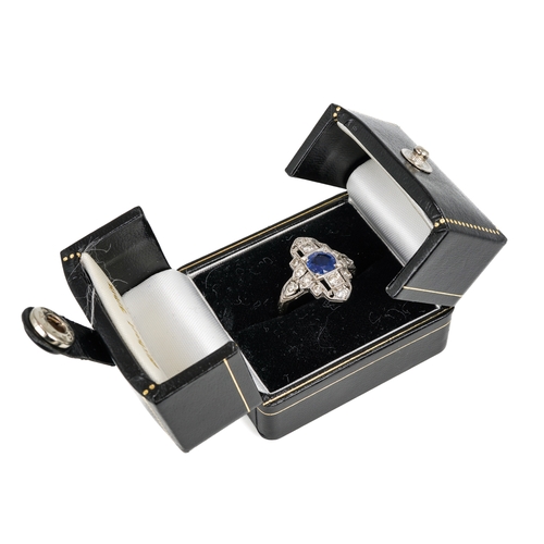 102 - An Art Deco platinum sapphire and diamond dress ring, the central round cut sapphire approx 6.2mm di... 