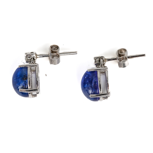 107 - A pair of 18ct white gold tanzanite and diamond stud earrings, set with two oval cabochon tanzanites... 