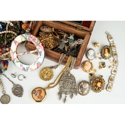 111 - A collection of costume jewellery, including beads, necklaces, malachite, silver chains and medallio... 