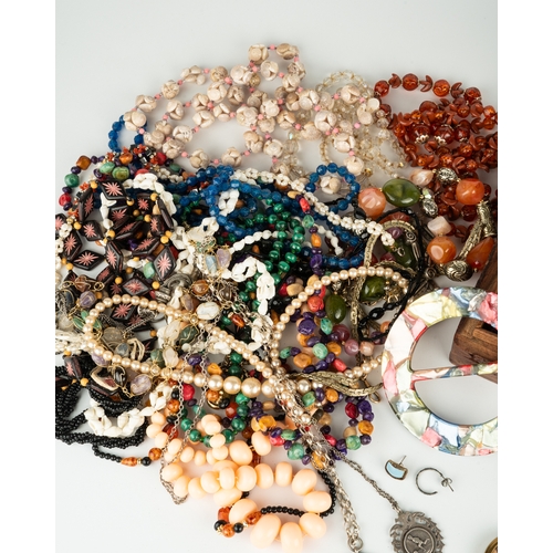 111 - A collection of costume jewellery, including beads, necklaces, malachite, silver chains and medallio... 