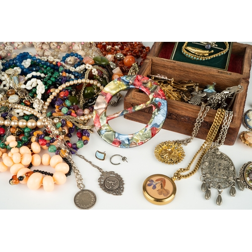 111 - A collection of costume jewellery, including beads, necklaces, malachite, silver chains and medallio... 