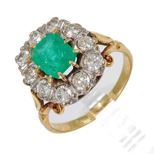 114 - An 18ct yellow gold emerald and diamond cluster ring, the step-cut emerald surrounded by ten round d... 