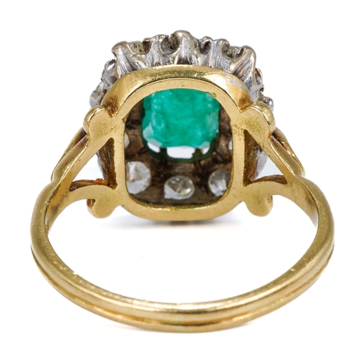 114 - An 18ct yellow gold emerald and diamond cluster ring, the step-cut emerald surrounded by ten round d... 