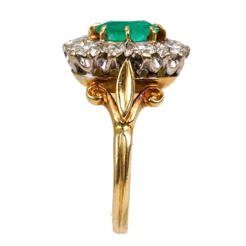 114 - An 18ct yellow gold emerald and diamond cluster ring, the step-cut emerald surrounded by ten round d... 