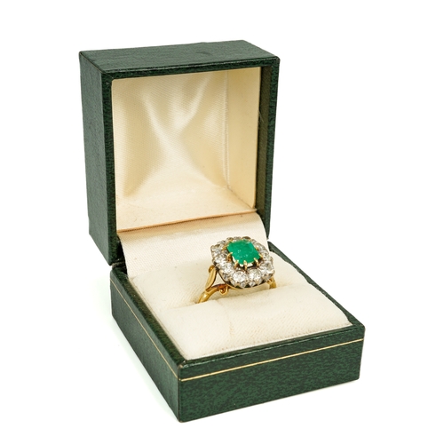 114 - An 18ct yellow gold emerald and diamond cluster ring, the step-cut emerald surrounded by ten round d... 