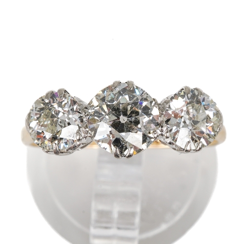 121 - An 18ct yellow gold and diamond three stone ring, set with old-cut diamonds, the centre stone approx... 