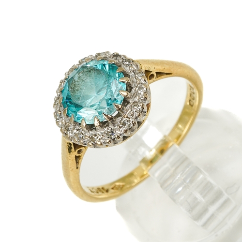 129 - An 18ct yellow gold zircon and diamond cluster ring, the round-cut blue zircon within a border of sm... 