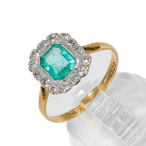 131 - An 18ct yellow gold emerald and diamond ring, the emerald-cut stone surrounded by fourteen round cut... 