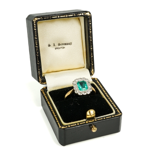 131 - An 18ct yellow gold emerald and diamond ring, the emerald-cut stone surrounded by fourteen round cut... 