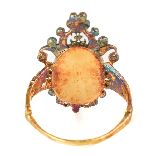 134 - An early 19th century yellow gold gem-set portrait ring, set with an oval portrait of a lady painted... 