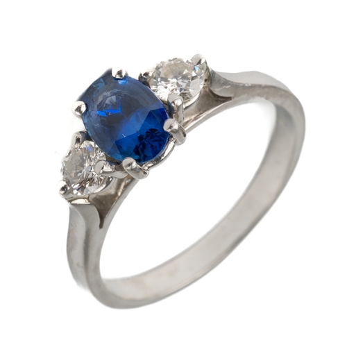 139 - A platinum sapphire and diamond three-stone ring, the central oval-cut sapphire approx 6.8mm x 4.8mm... 