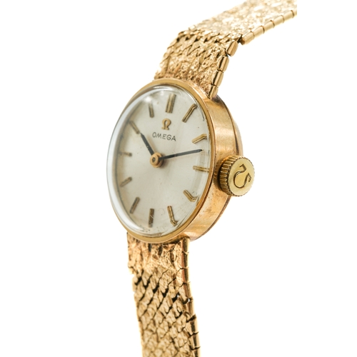 172 - A ladies 9ct yellow gold Omega wristwatch, the circular silvered dial with baton indicators, integra... 