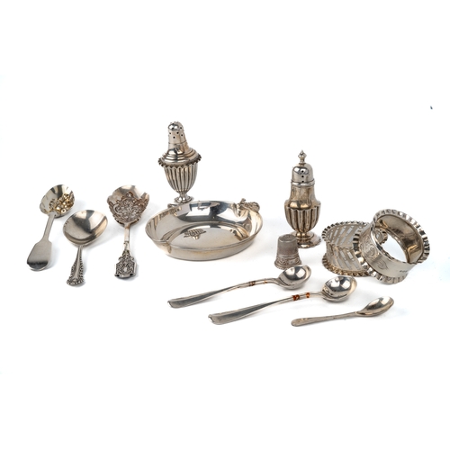 177 - A collection of silver including napkin rings, pepperettes, assorted spoons, continental thimble, to... 