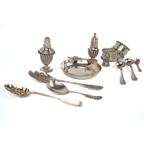 177 - A collection of silver including napkin rings, pepperettes, assorted spoons, continental thimble, to... 