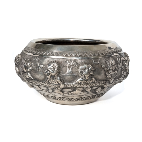 181 - A large Burmese silver bowl, 19th century, repousse decorated with 7 headed snake and  figures with ... 