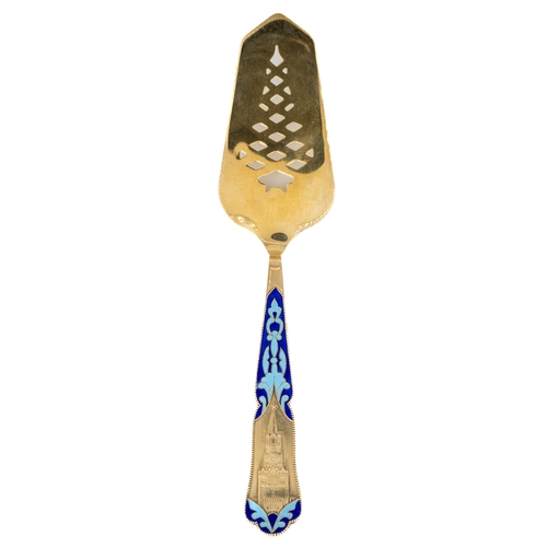 189 - A Russian silver-gilt and enamel cake slice, the handle cast in relief depicting the Kremlin clock t... 