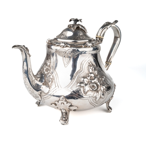 197 - An early Victorian silver teapot, the hinged domed cover with floral finial, the body embossed with ... 