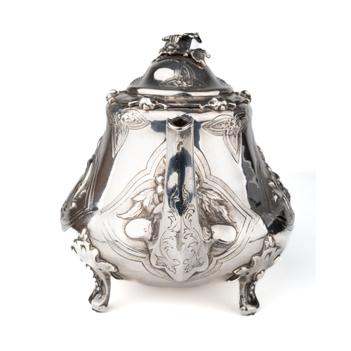 197 - An early Victorian silver teapot, the hinged domed cover with floral finial, the body embossed with ... 