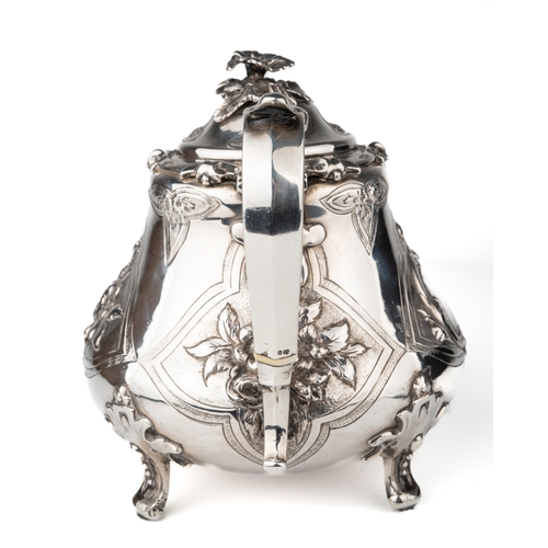 197 - An early Victorian silver teapot, the hinged domed cover with floral finial, the body embossed with ... 