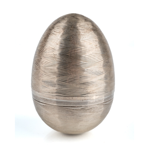 198 - Nicholas Plummer - A silver surprise egg, in the manner of Stuart Devlin, the engine-turned case ope... 