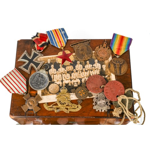 234 - Military interest to include 1939 Iron Cross, French medals, dog tags, cap badges and various coinag... 