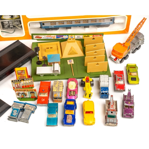 261 - A collection of boxed Lima model trains and associated model railway furniture and die cast cars. Tr... 