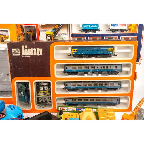 261 - A collection of boxed Lima model trains and associated model railway furniture and die cast cars. Tr... 