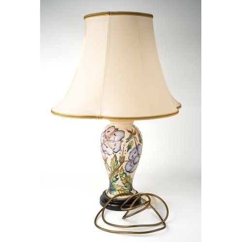 389 - A Moorcroft 'Meadow Cranesbill' pattern baluster lamp, designed by Phillip Gibson, on a wooden base,... 