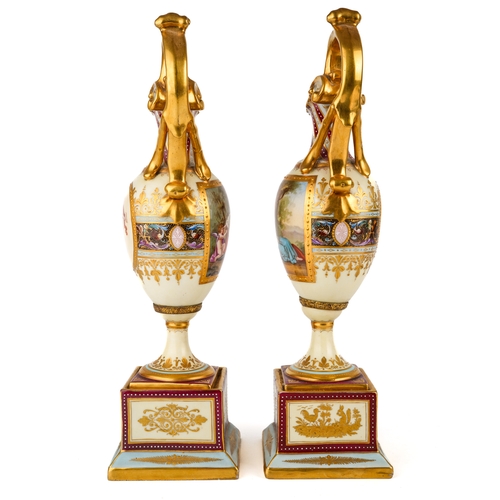 404 - A pair of late 19th century Vienna porcelain pedestal ewers, each of Neo-Classical tapering outline ... 