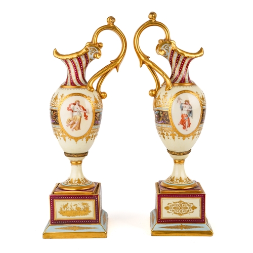 404 - A pair of late 19th century Vienna porcelain pedestal ewers, each of Neo-Classical tapering outline ... 