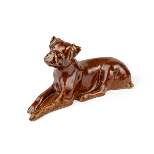 414 - A salt glazed model of a reclining dog / boxer, aprox 15cm long, 8cm high