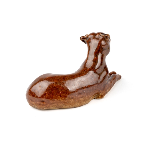 414 - A salt glazed model of a reclining dog / boxer, aprox 15cm long, 8cm high