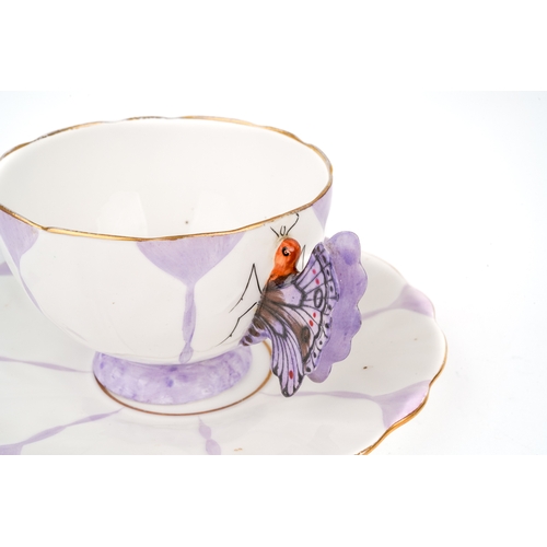 416 - An Aynsley purple butterfly handle cup and saucer, marked to base, Reg No. 765788