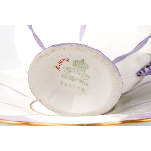 416 - An Aynsley purple butterfly handle cup and saucer, marked to base, Reg No. 765788