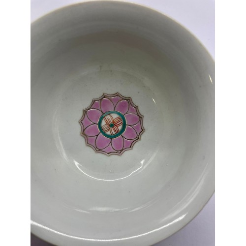 423 - A Chinese bowl, everted rim, the centre with enamelled lotus flower, the exterior enamelled with fig... 