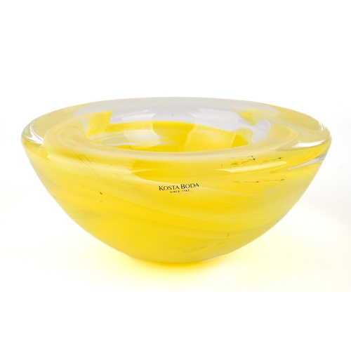 513 - A yellow Kosta Boda bowl with swirl design, 17.5cm diameter, 8cm high, with original label on