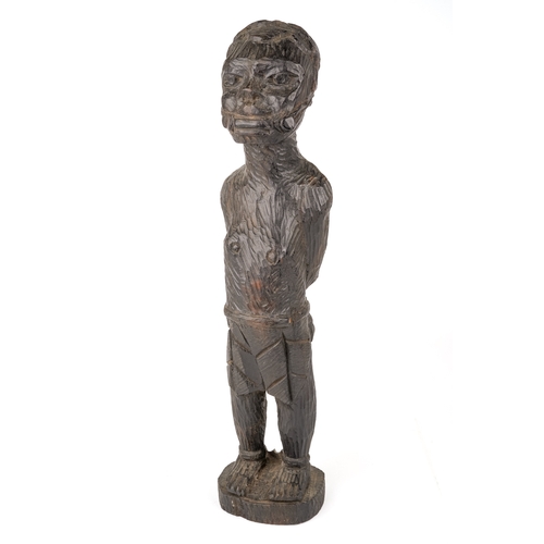 523 - An African carved wooden slave figure in chains and chocker , 37 cm.